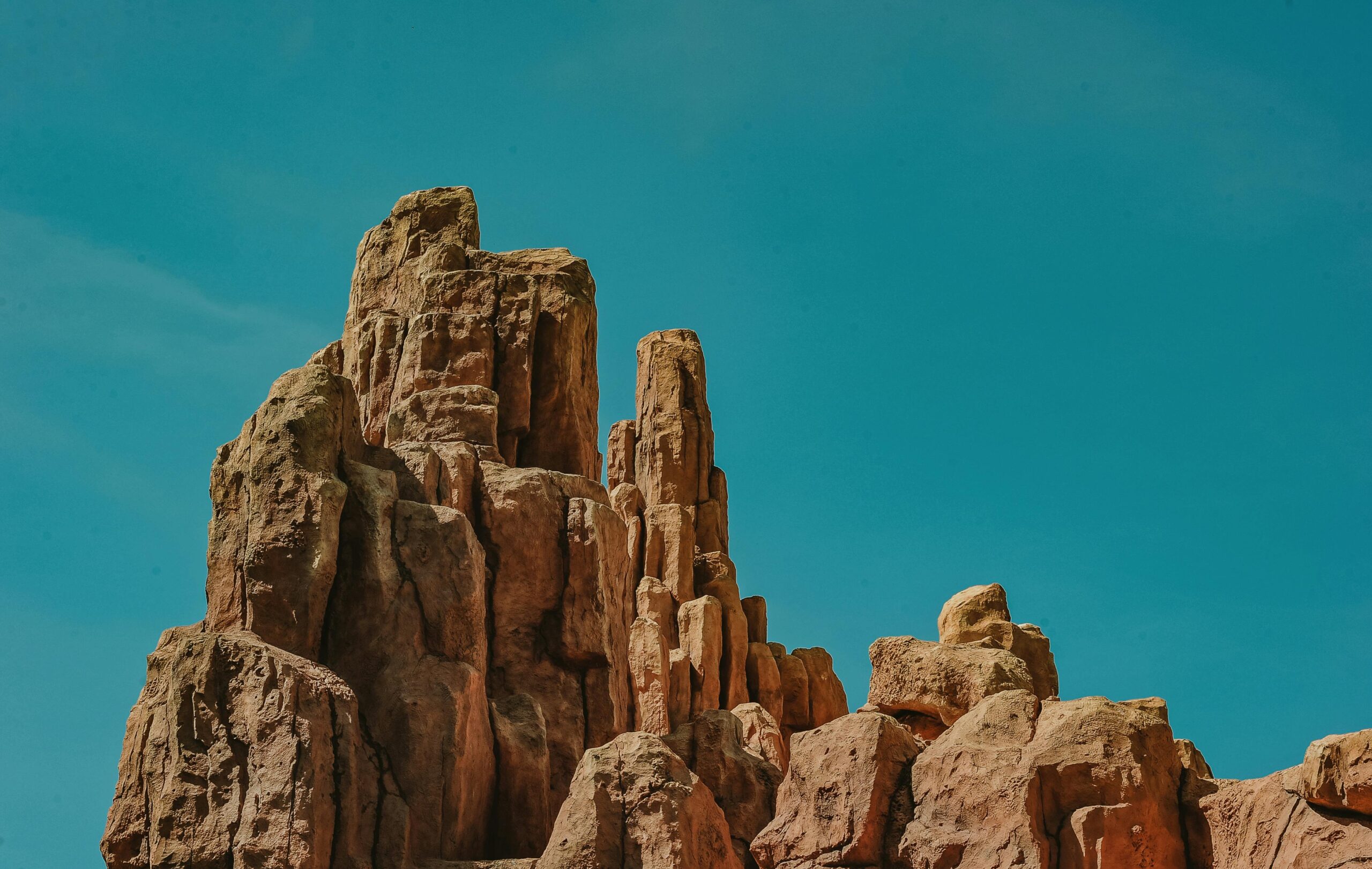 Dramatic sandstone rock formations against a vivid blue sky, capturing natural beauty.